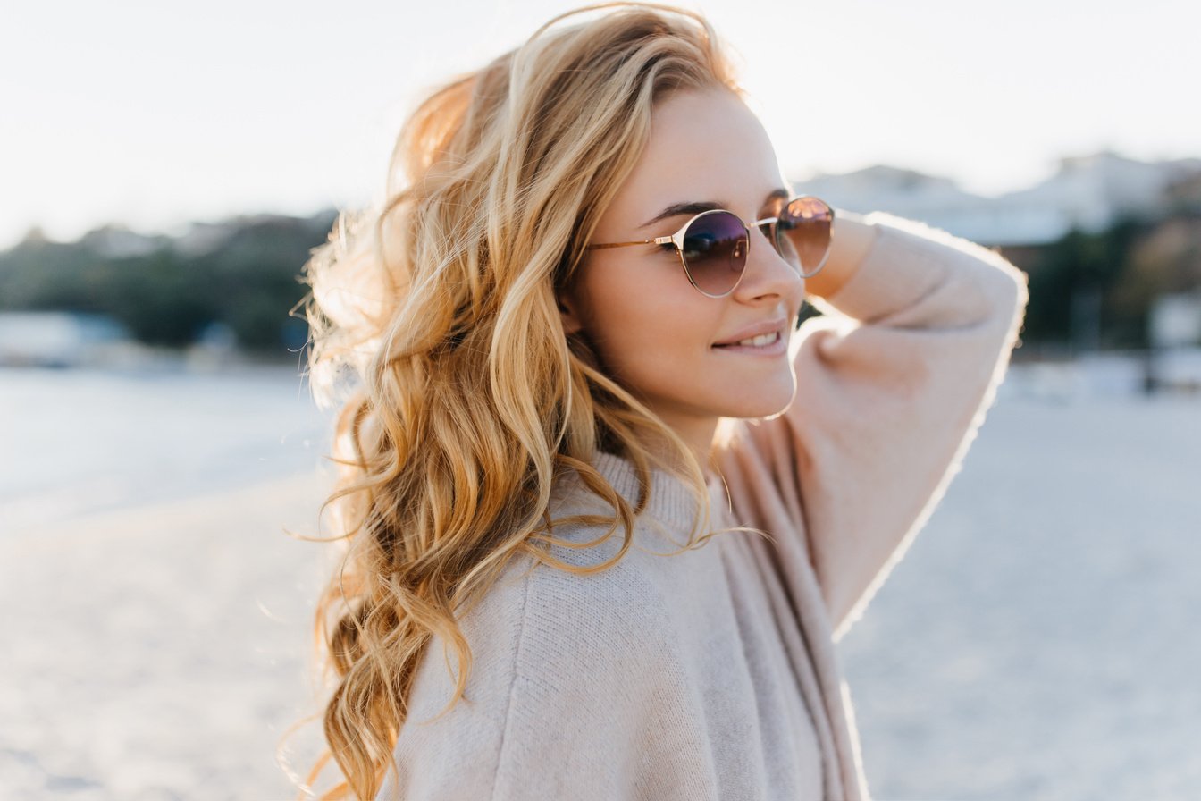 Close-up Portrait of Young Girl without Make-up Posing on Beach in Cashmere Sweater and Glasses